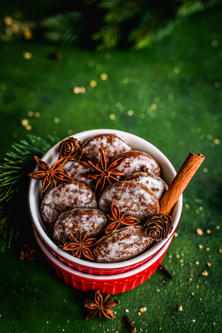 Gingerbread cookies with Christmas spices in dessert molds on a green background