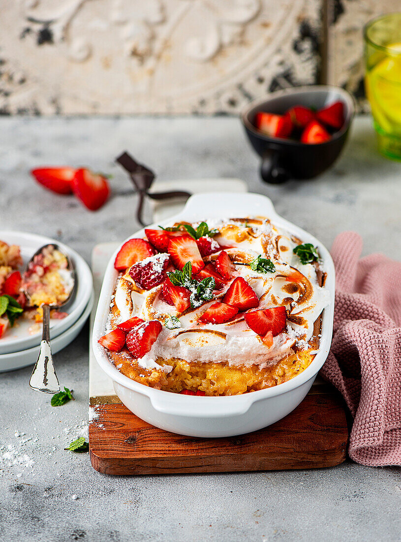 Rice pudding casserole with strawberries and meringue topping
