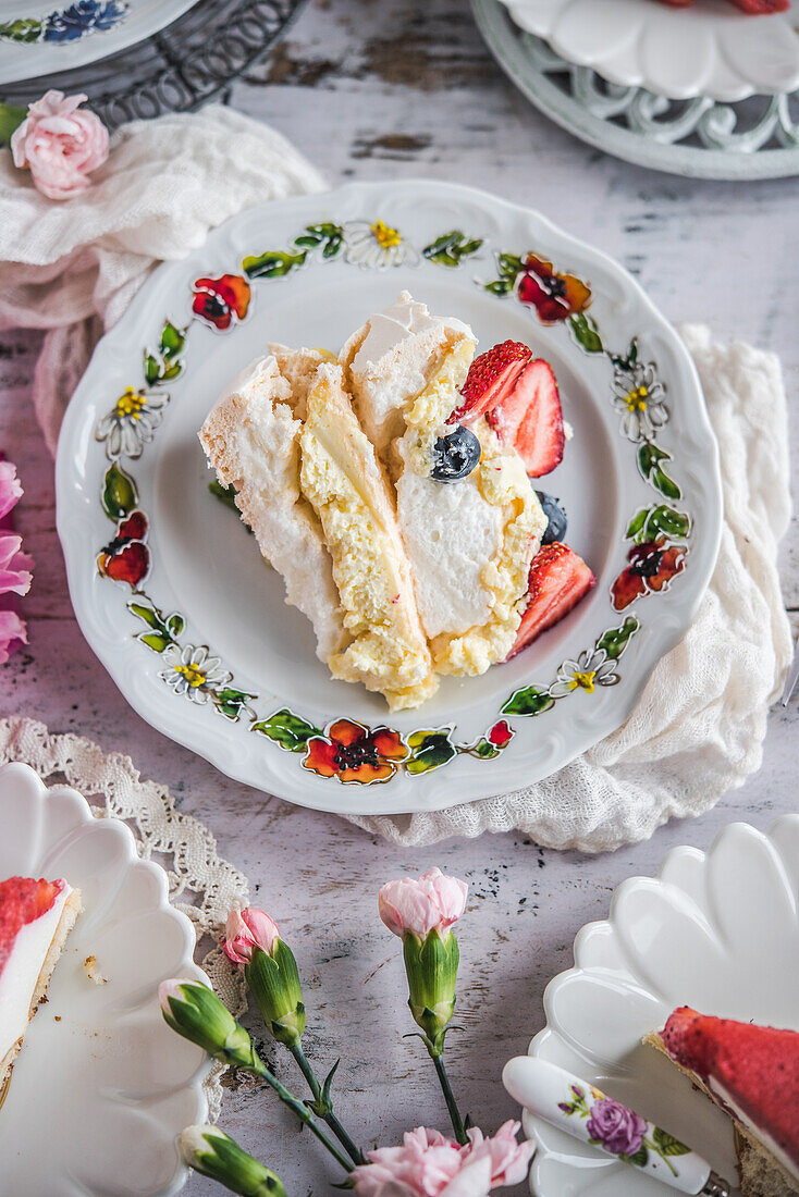 Meringue cake with berries on a spring table
