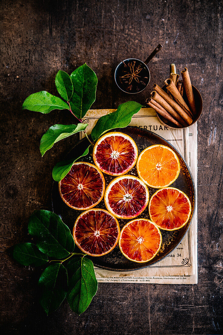 Still life with halved blood oranges and spices