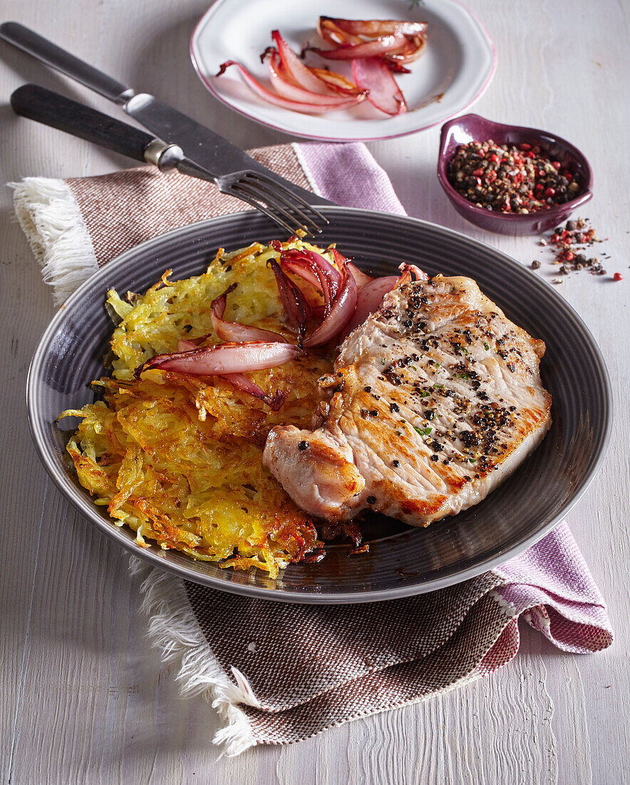 Pepper pork chops with potato pancakes