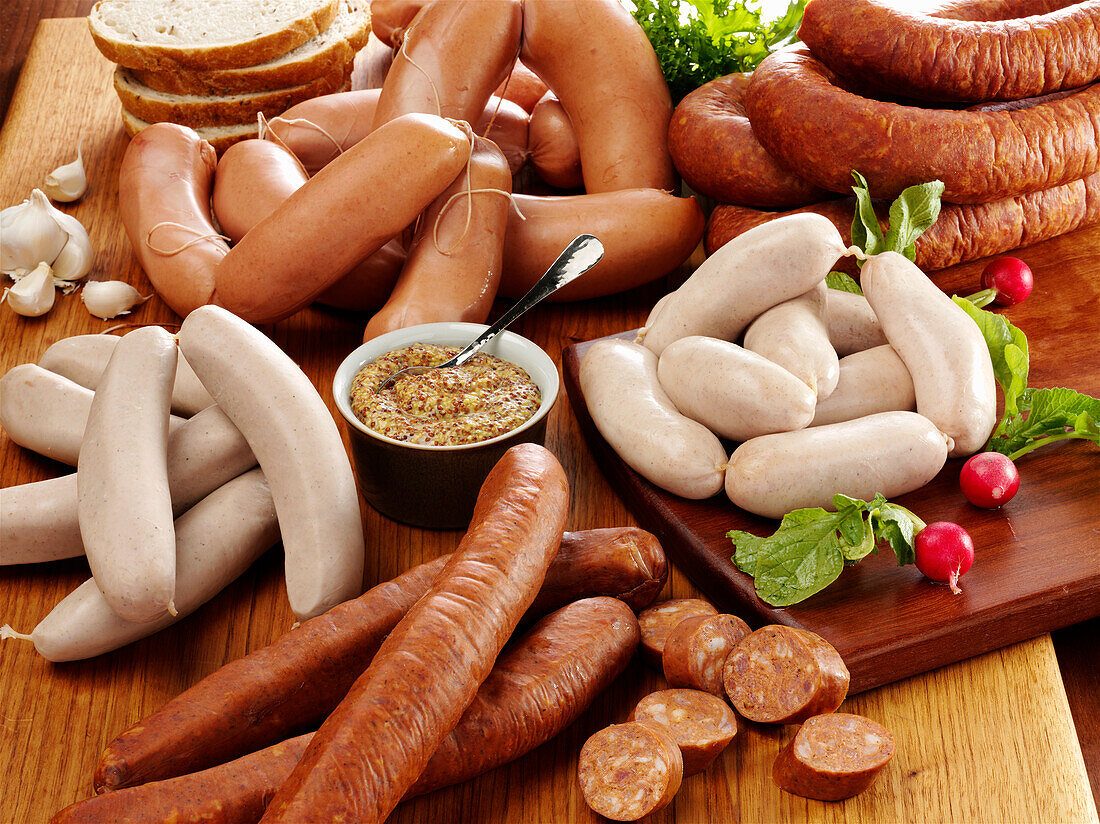 Assortment of raw ethnic sausages with course grain mustard radish and rye bread