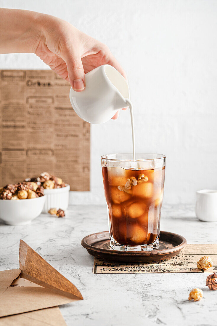 Iced coffee with pouring cream