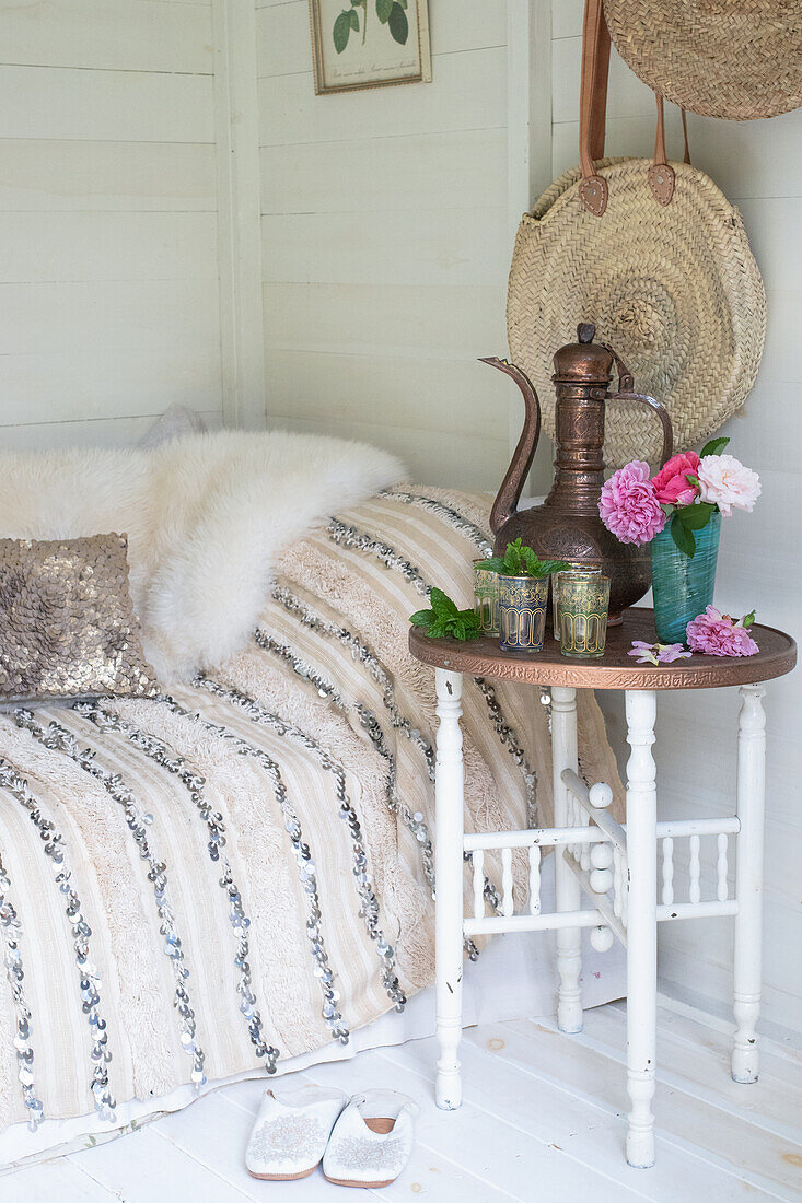 Daybed in summerhouse with vintage side table