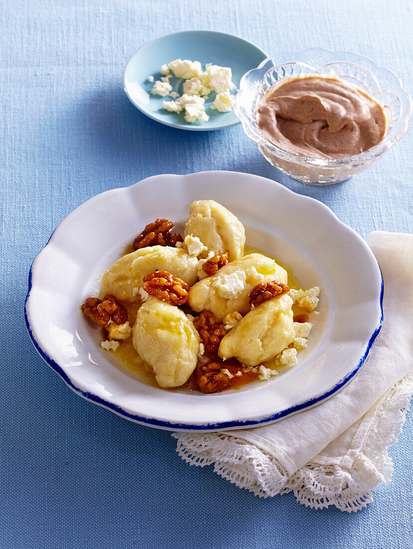 Sweet gnocchi with nuts and damsoncheese cream