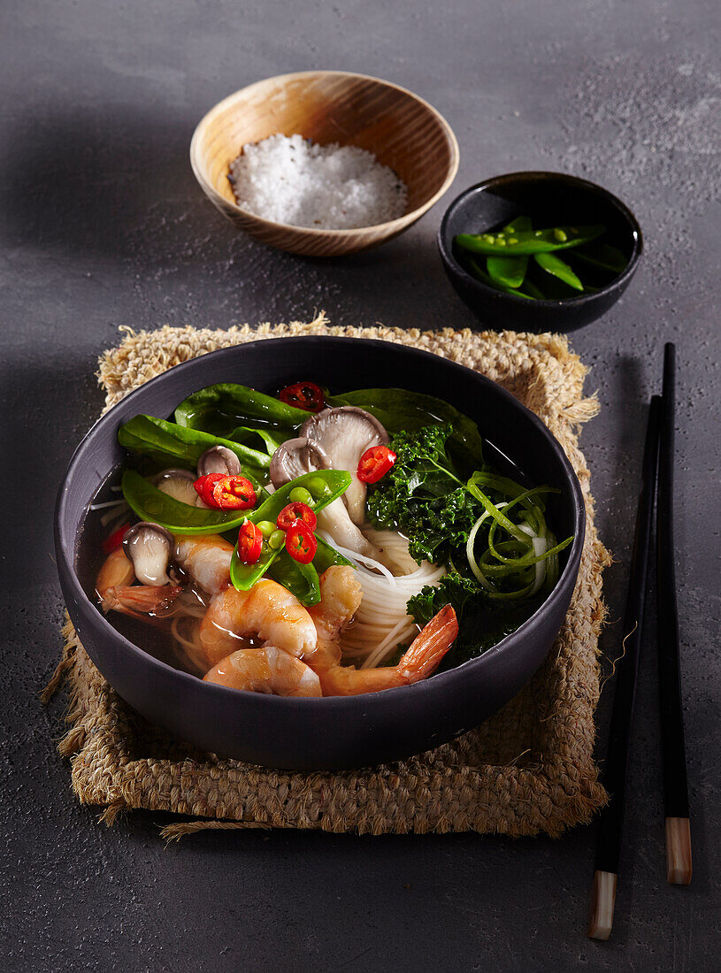 Asian noodle soup with mushrooms and shrimps