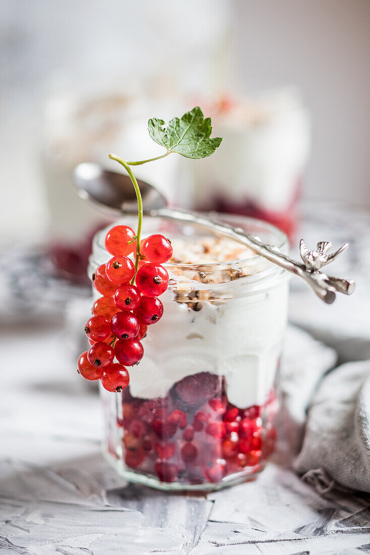 Yogurt parfait with fresh redcurrants and nuts