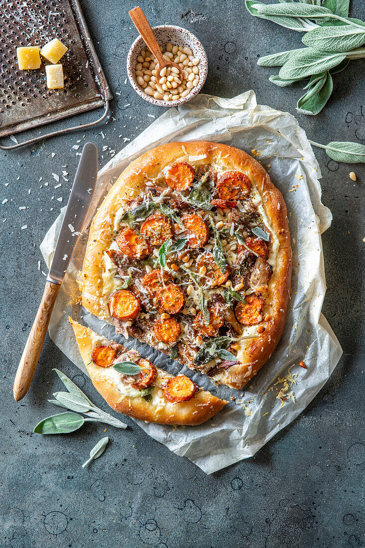 Pizza with carrots, duck confit and sage