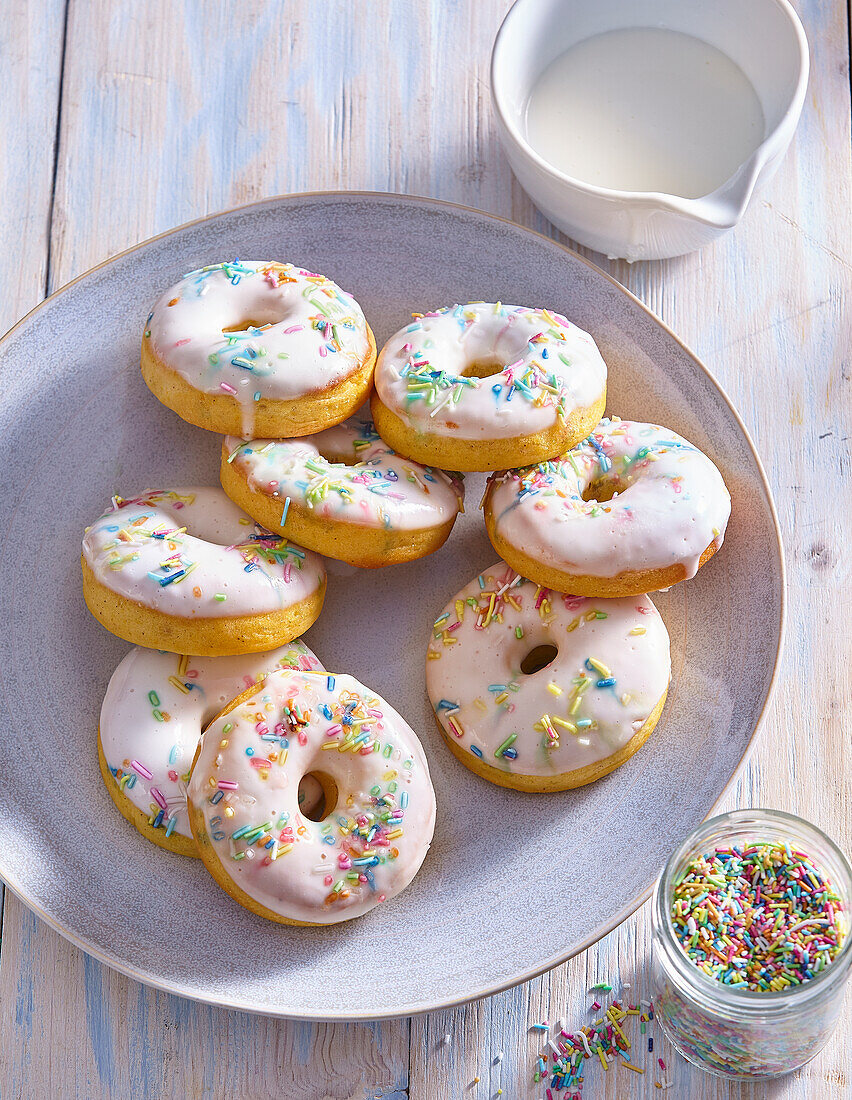 Carrot donuts with yogurt glaze and colored sugar sprinkles