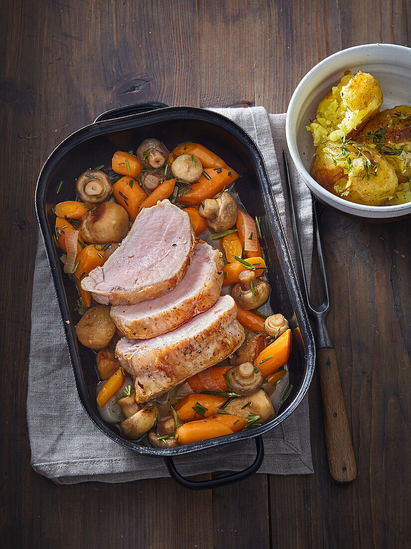 Roast pork with carrot and mushrooms