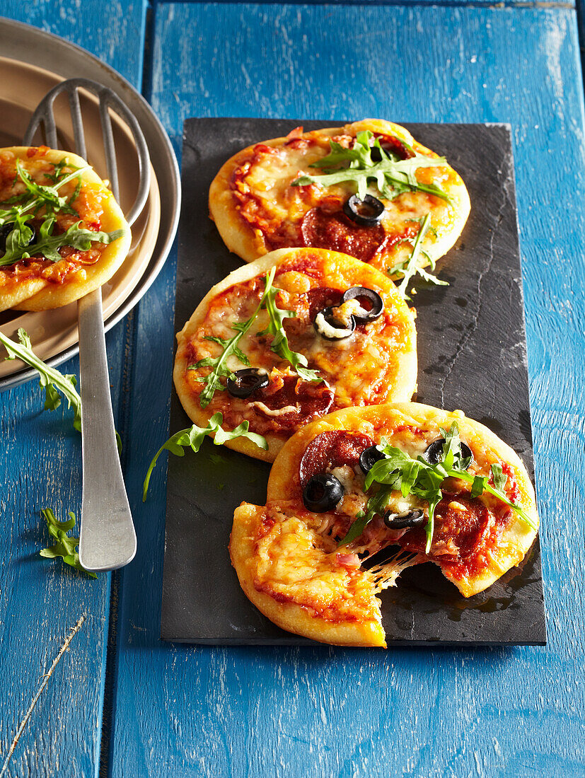 Mini pizza with sausage and olives