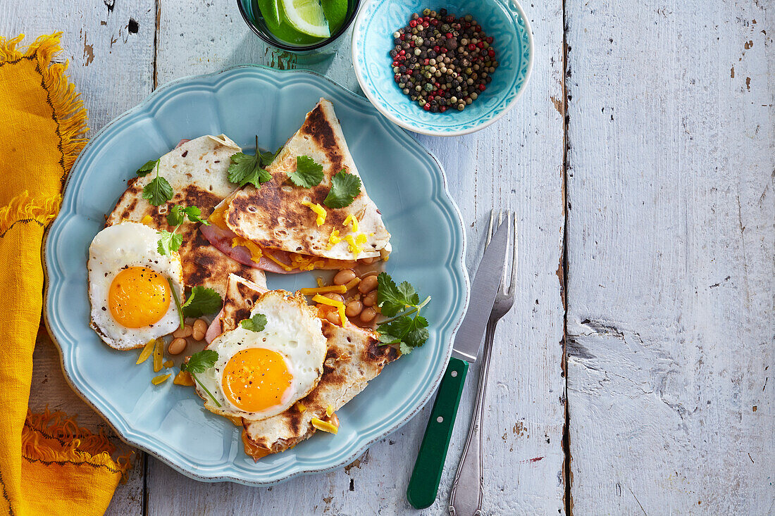 Quesadilla with beans, ham and fried eggs