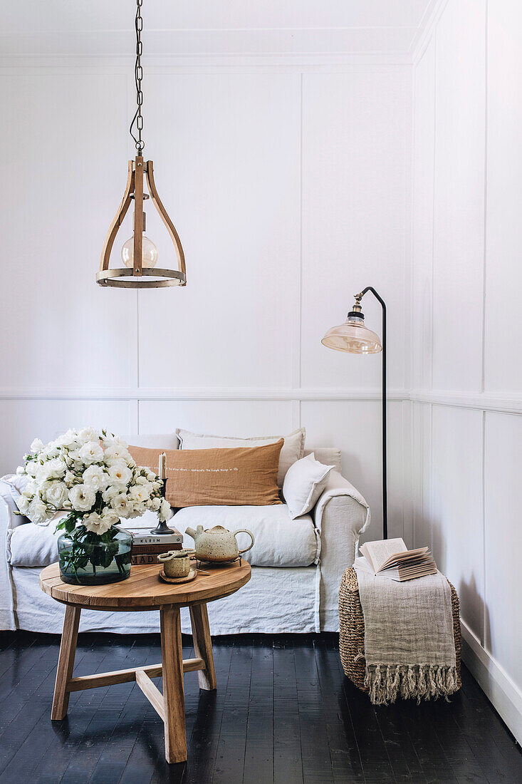 Small sofa in natural-toned living room with wall paneling