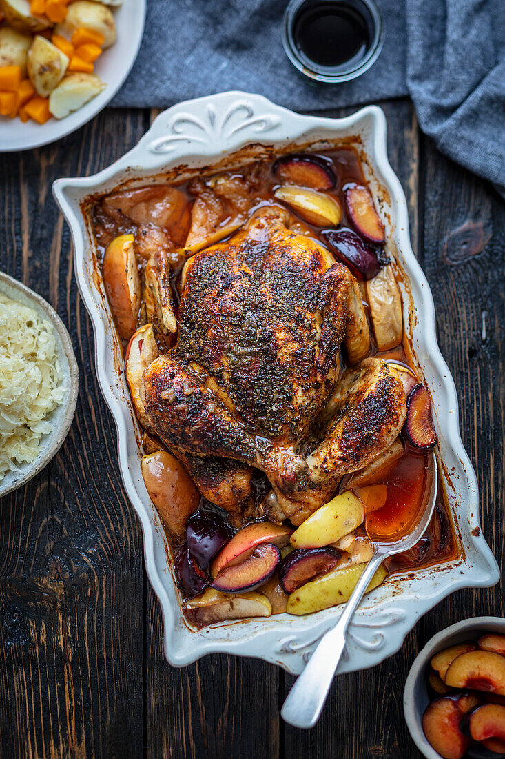 Oven-baked chicken with plums and apples