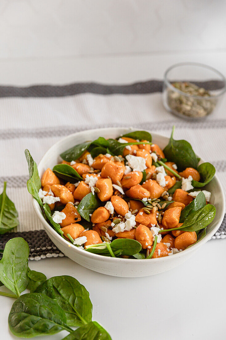 Pumpkin gnocchi with Feta salad and baby spinach leaves