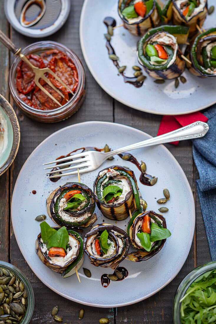 Grilled aubergine rolls with courgette, bell pepper, cream cheese and dried tomatoes