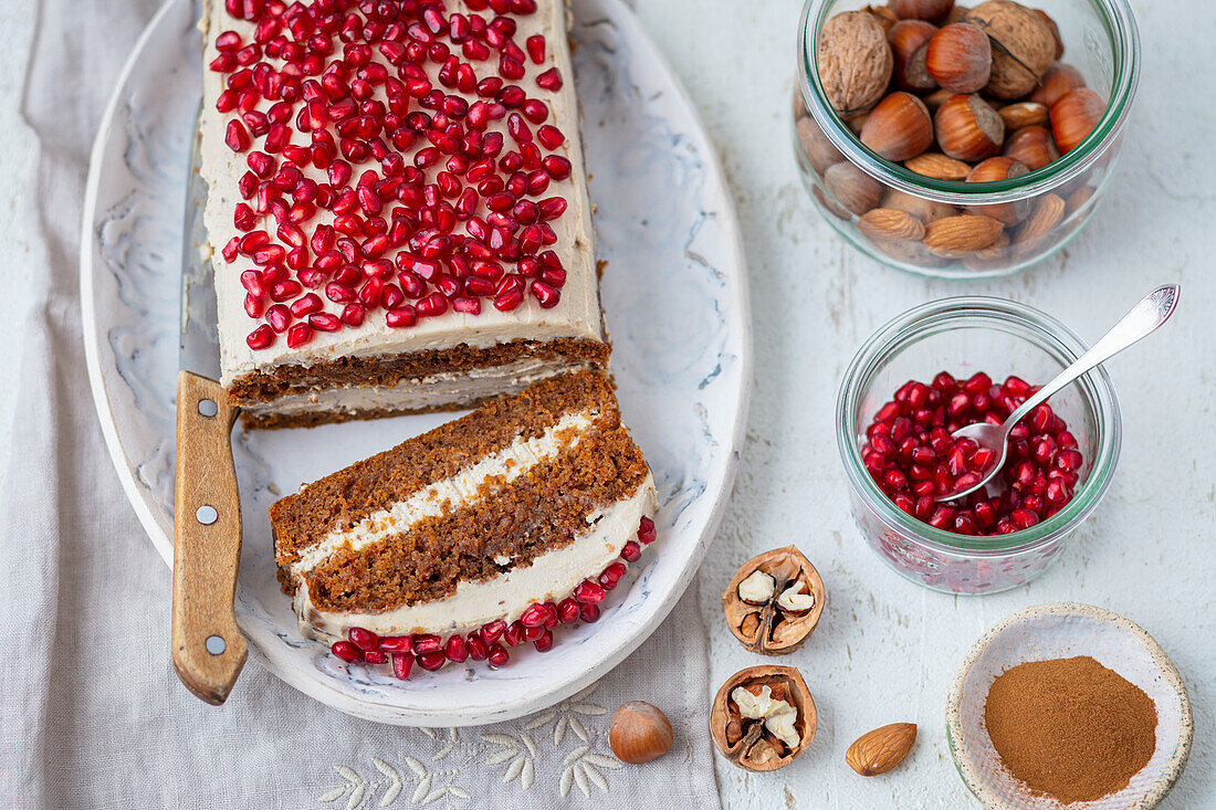 Carrot cake with cream cheese and pomegranate seeds