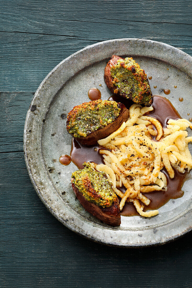 Deer medallions with a herb and nut crust and spaetzle