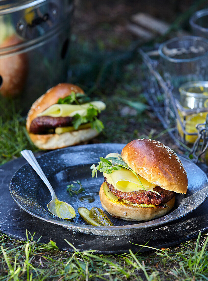 Beef burger with cheese and pickled cucumber