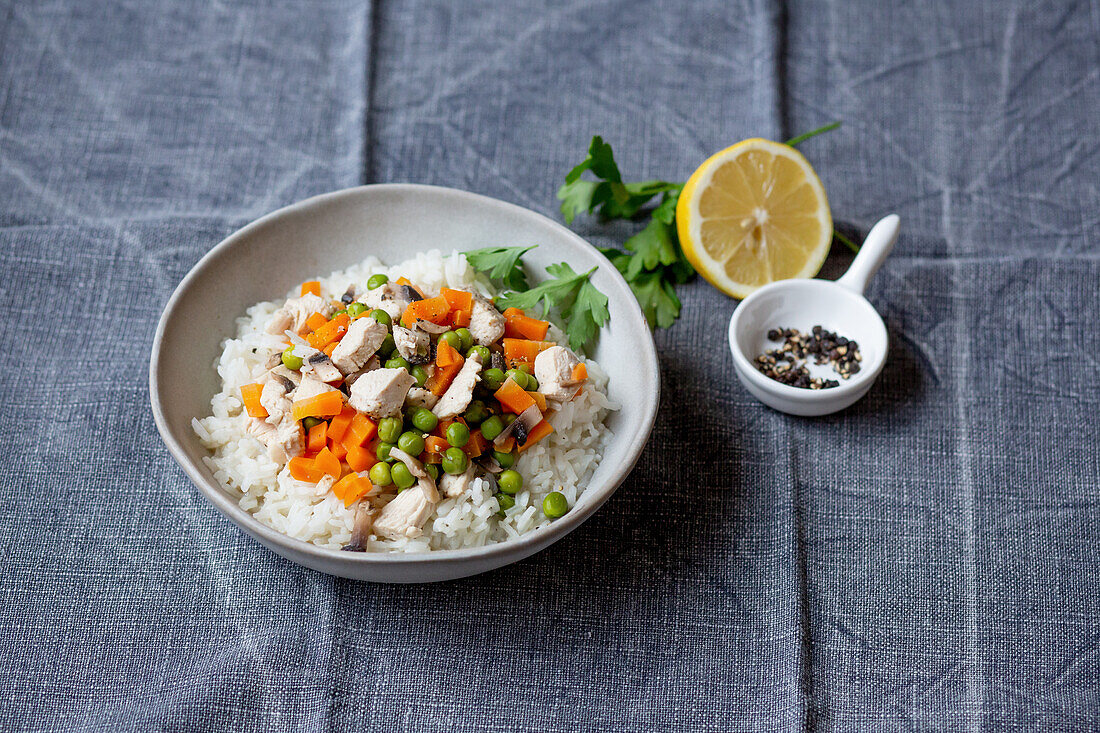 Chicken fricassee with carrots and peas on rice