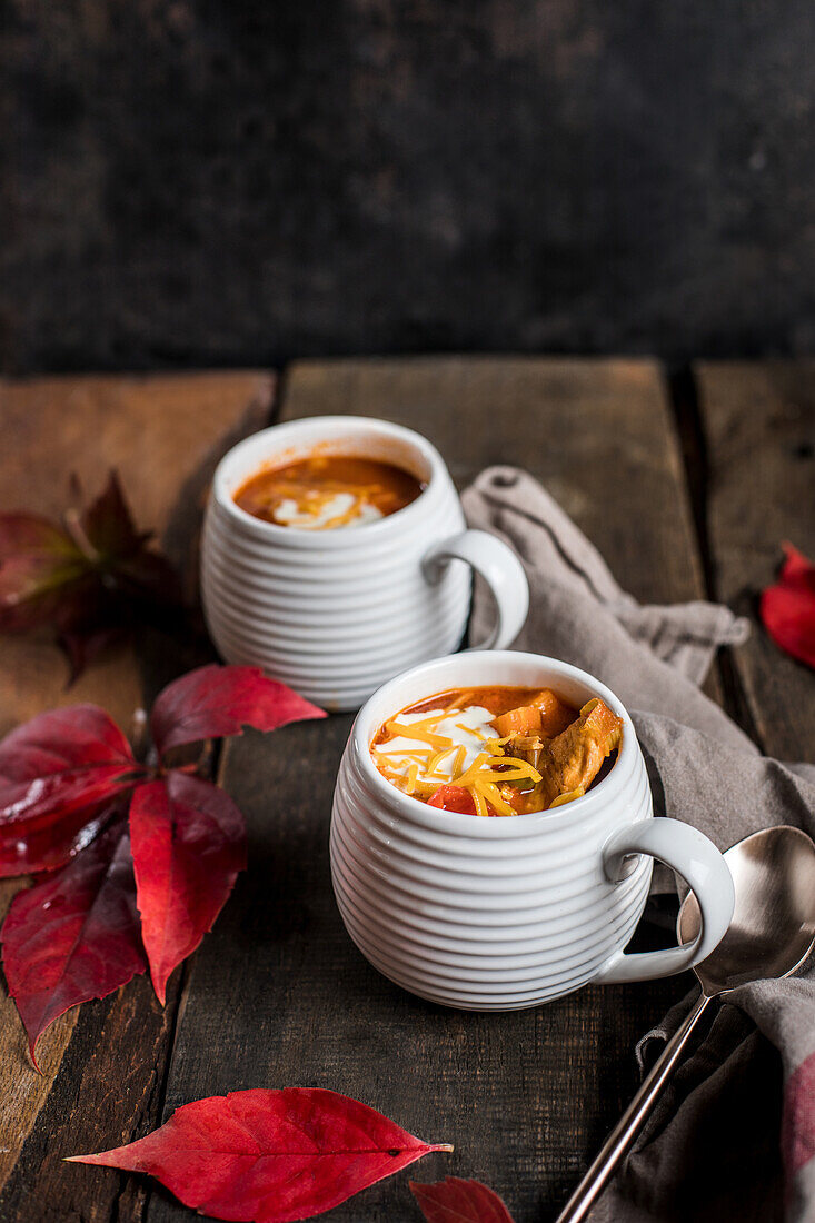 Spicy tomato soup with vegetables and cheddar