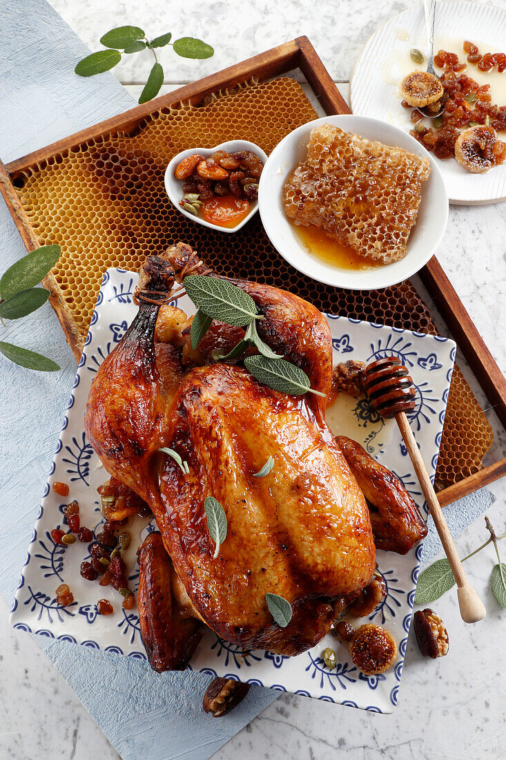 Baked chicken with nuts and raisins in honey
