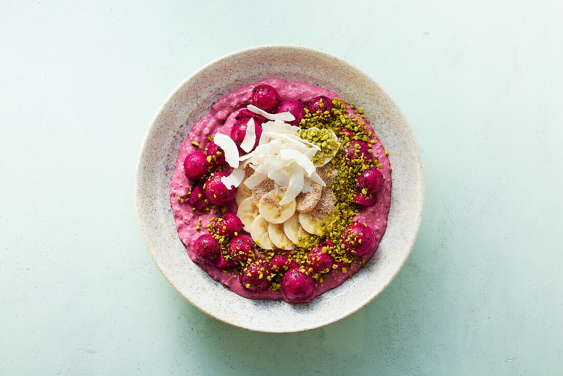 A smoothie bowl with silken tofu, raspberries and dragon fruit