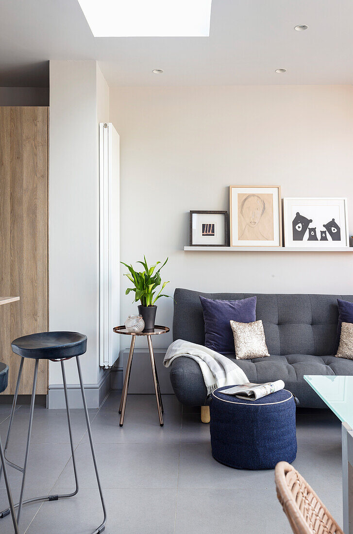 Grey sofa in open-plan interior with skylight