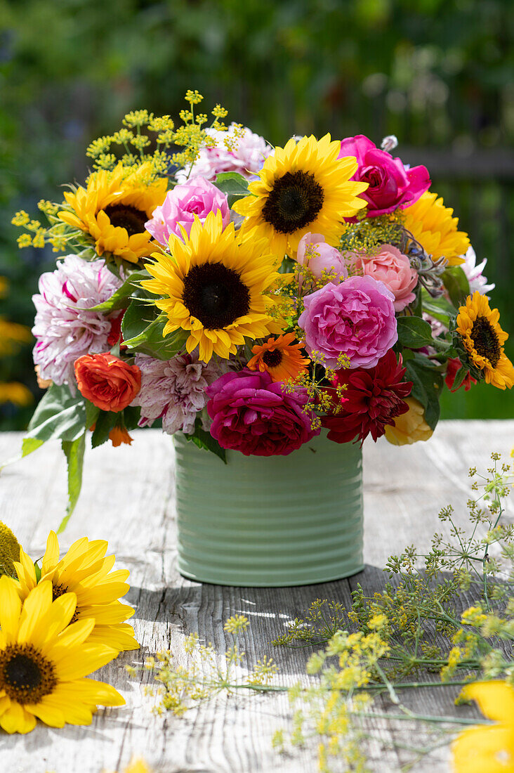 Colourful bouquet of roses, sunflowers, dahlias, marigolds and fennel flowers