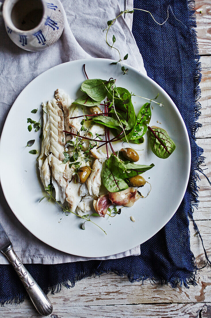 Sea bass baked in salt with lettuce leaves