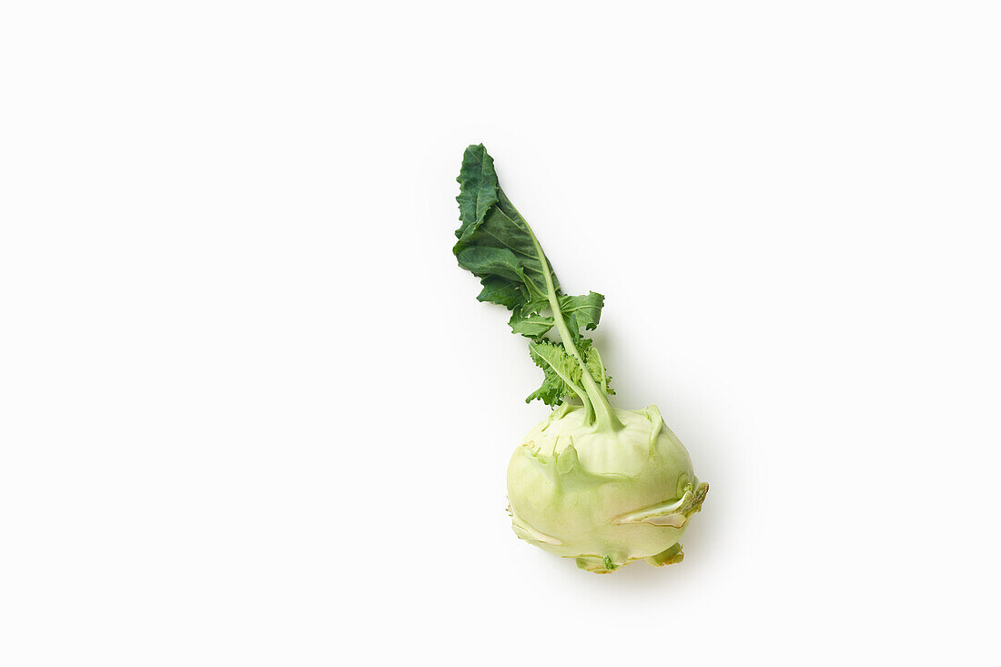 Flat lay with fresh raw kohlrabi on white background