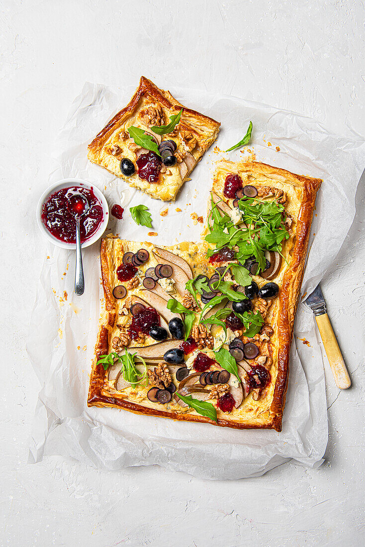 Puff pastry tart with blue cheese, pear, grapes, walnuts and cranberry sauce