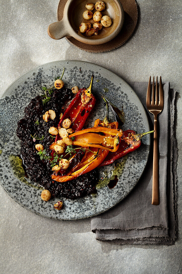Black risotto with chilli macadamia nuts and roasted peppers