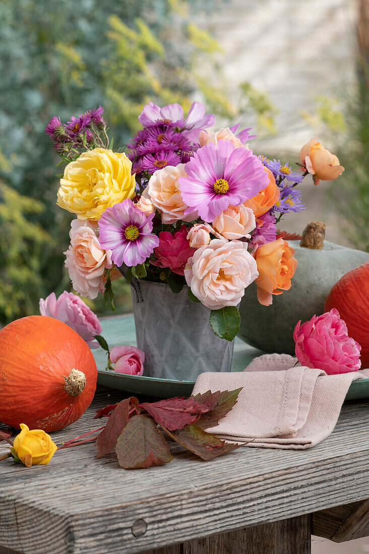 Autumn bouquet of roses, ornamental baskets and asters