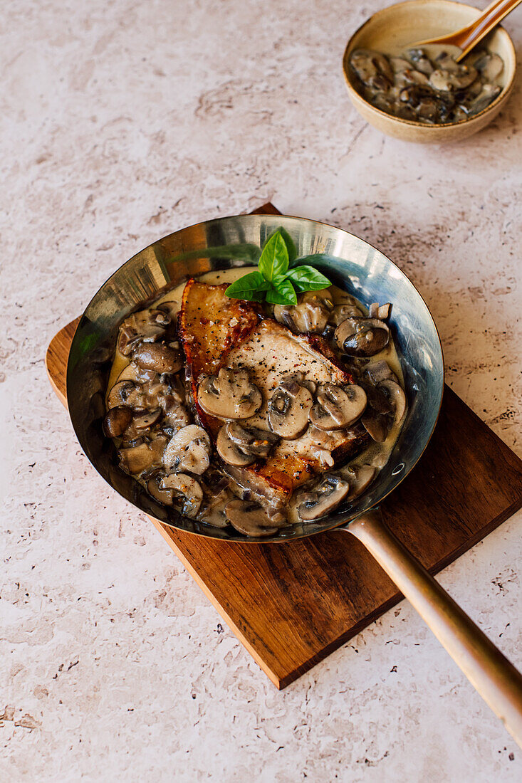 Grilled pork chop with mushrooms and fennel cream sauce