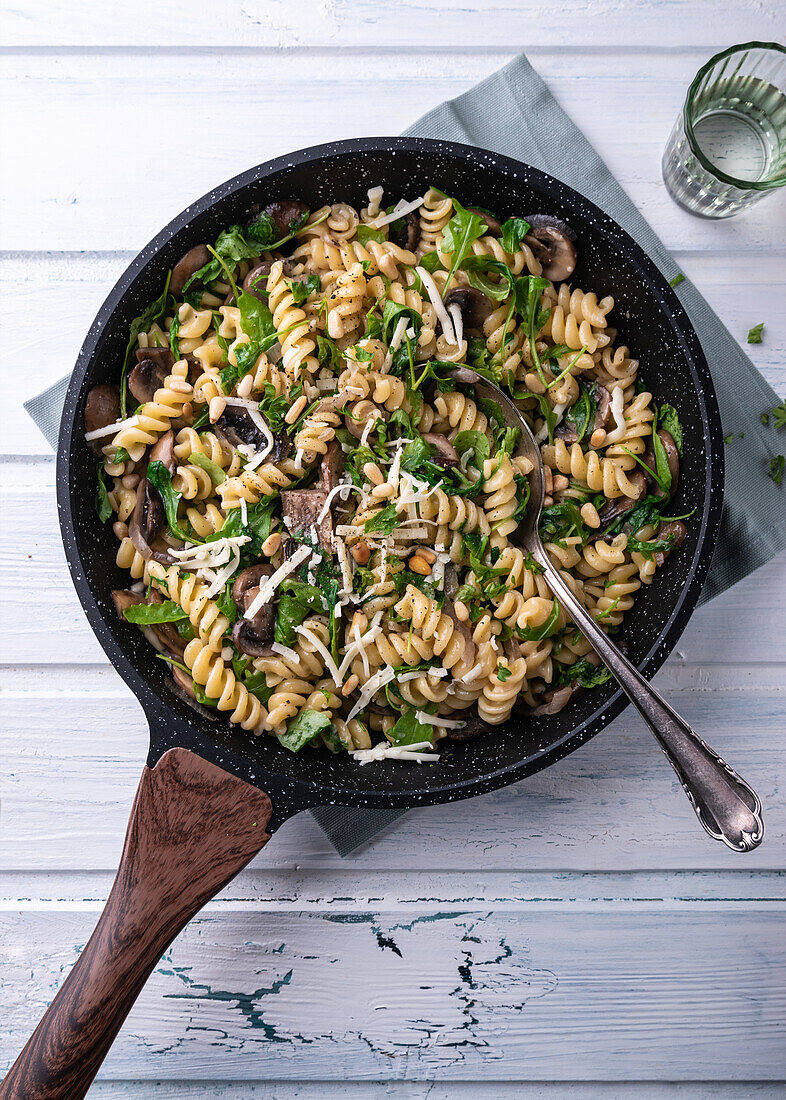 Vegan mushroom and rocket pasta with pine nuts and almond cheese