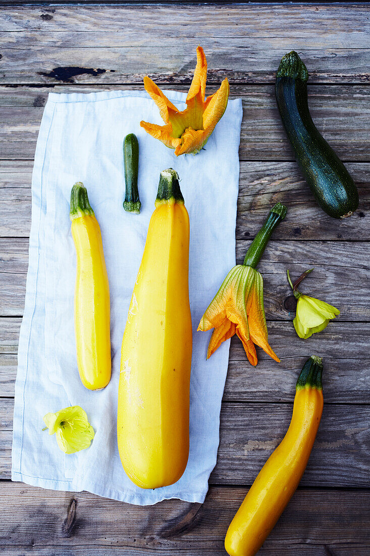 Yellow and green courgettes and courgette flowers