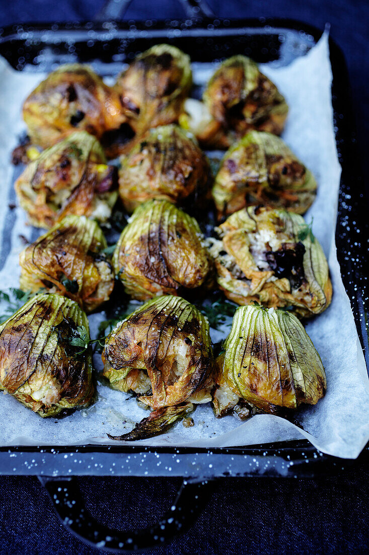 Stuffed baked courgette flowers
