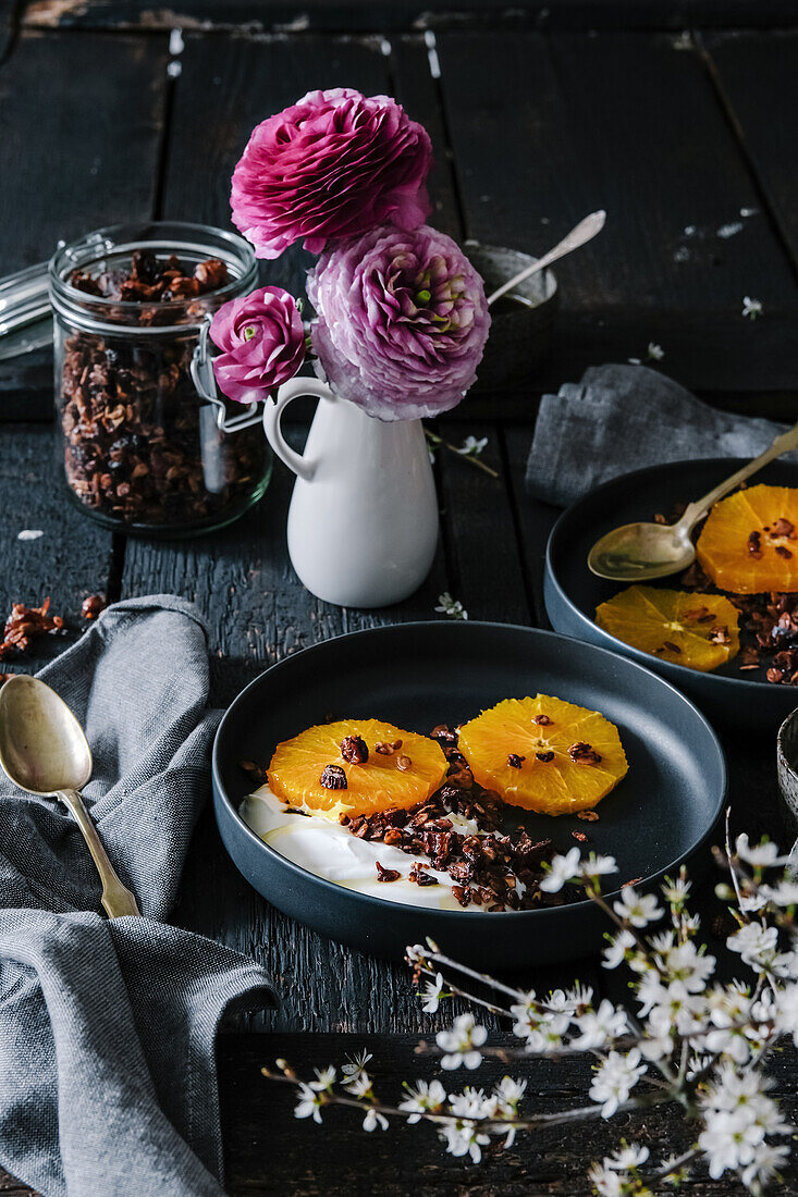 Granola breakfast with yoghurt and oranges