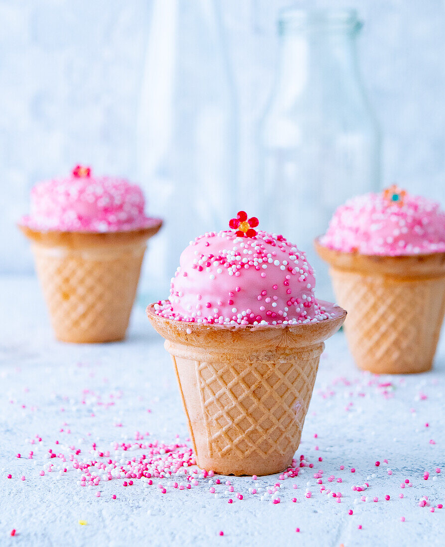 Pink strawberry tartlets with sugar sprinkles in cones