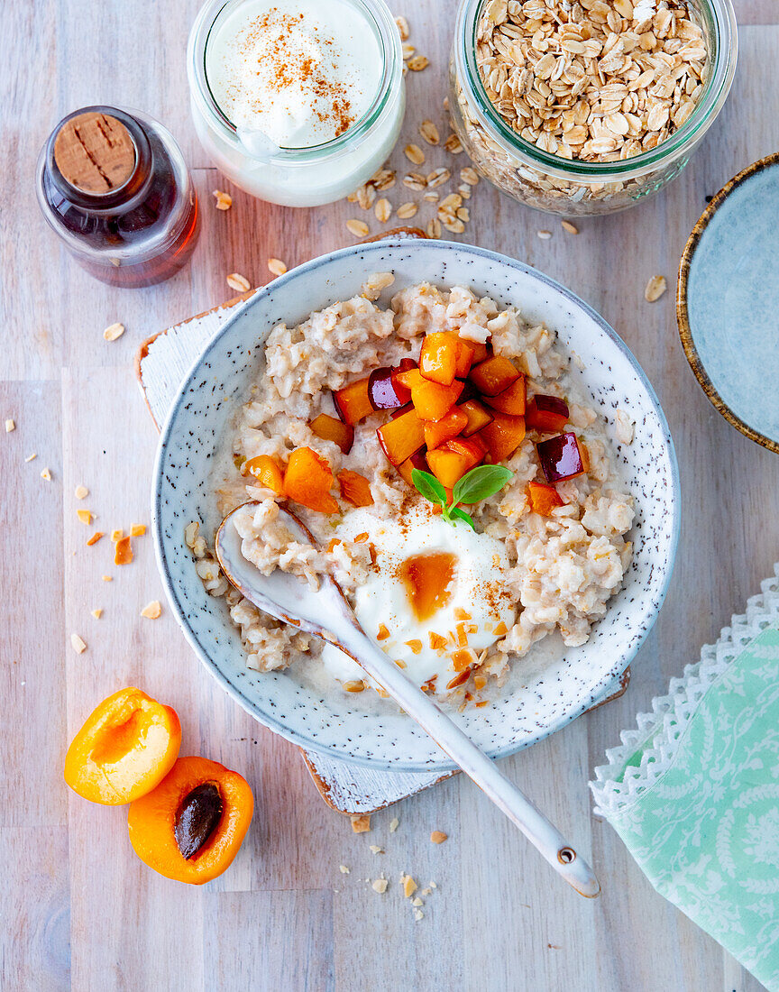 Porridge with plums, apricots, yoghurt and maple syrup