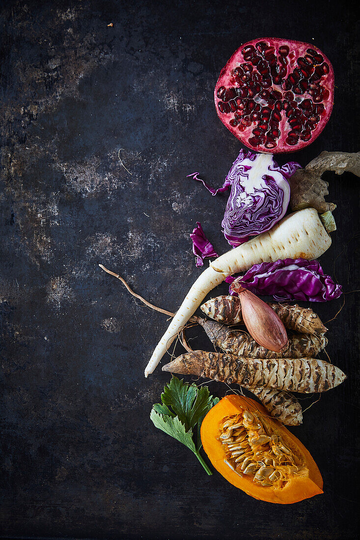 Winter vegetables and pomegranate on a dark background
