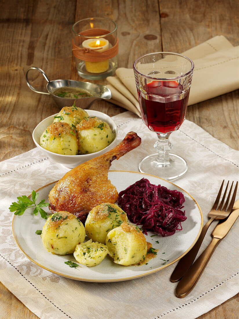 Duck leg with herb dumplings and red cabbage