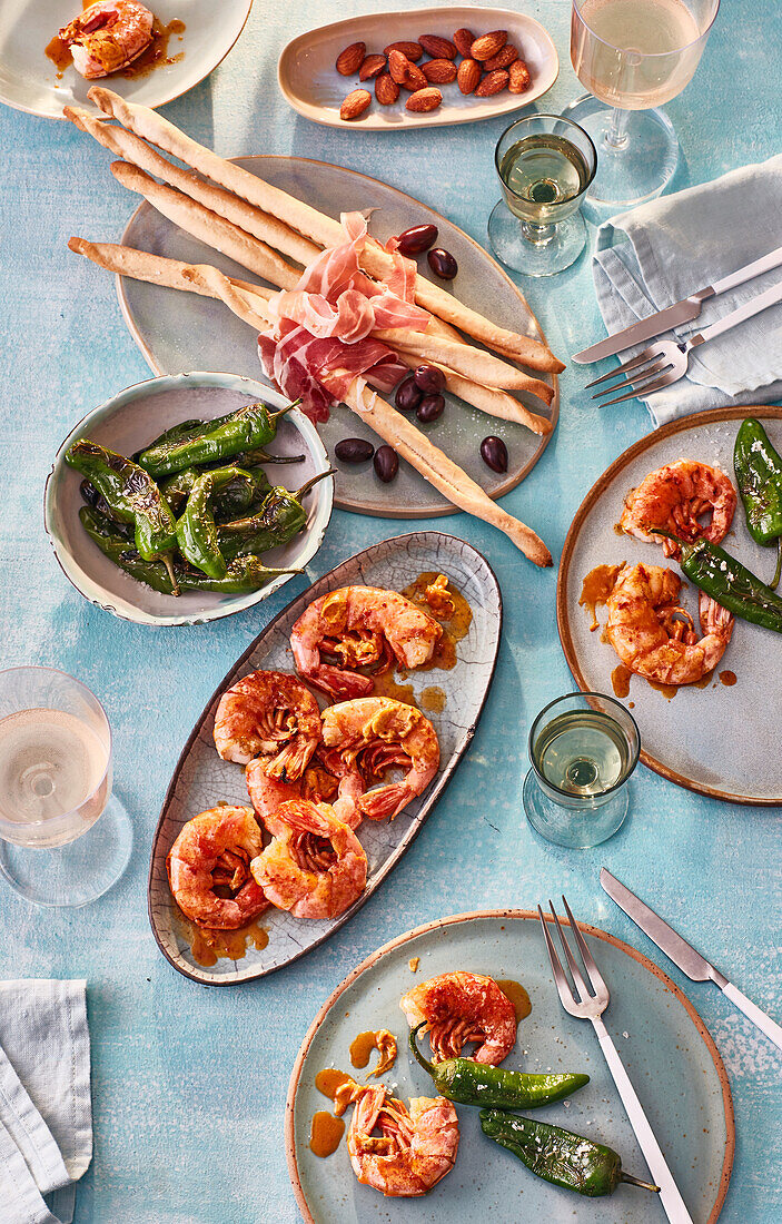 Tapas with grilled prawns and pimientos de padrón