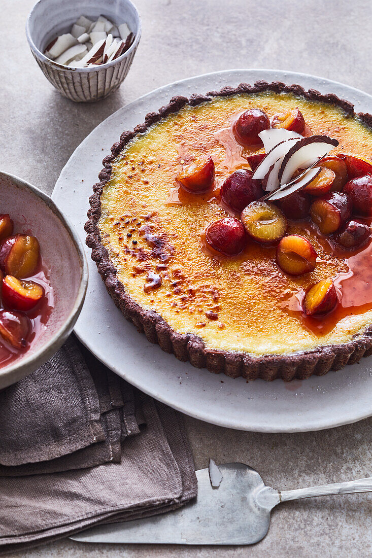 Coconut brûlée tart with caramelised plums