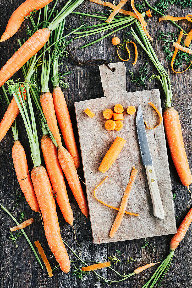 Organic carrots with wooden chopping board and knife