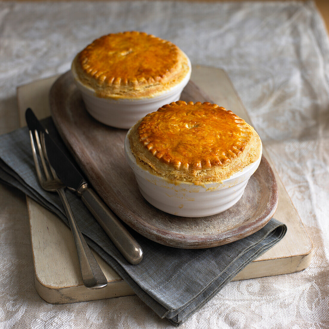 Two chicken pot pies on serving tray
