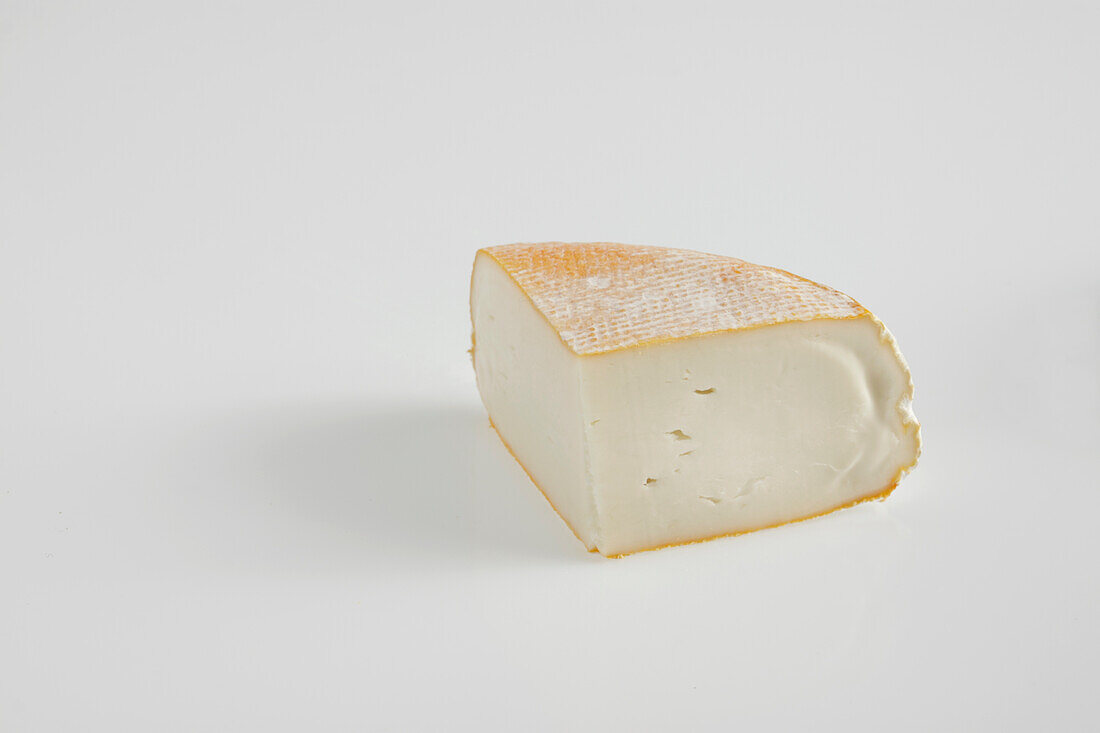 Slice of French petit fiance des Pyrenees goat's cheese