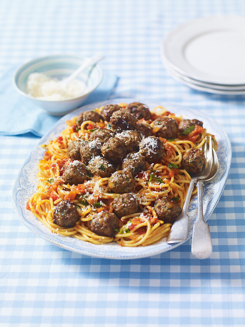 Spaghetti with meatballs and grated cheese