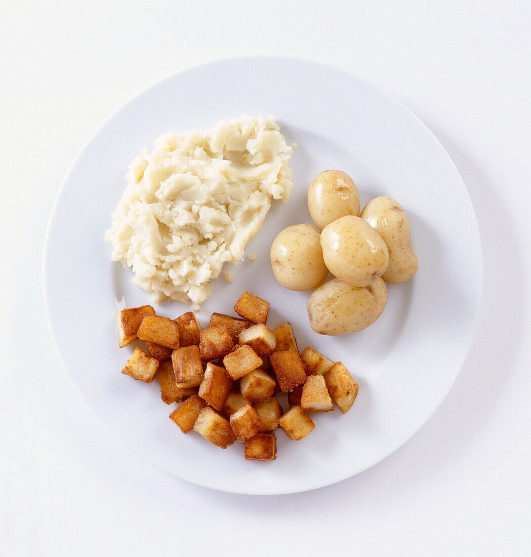 Mashed sauteed, and new potatoes on white plate